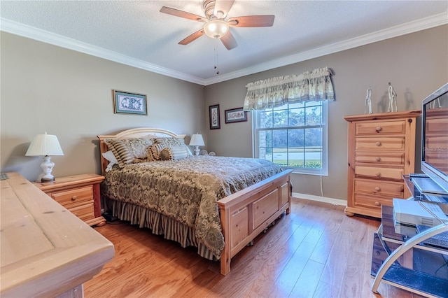 bedroom with ceiling fan, crown molding, a textured ceiling, and light wood-type flooring