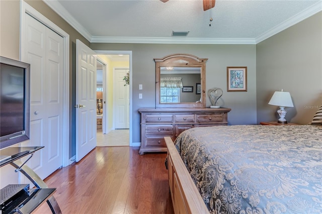 bedroom featuring ceiling fan, a textured ceiling, and ornamental molding