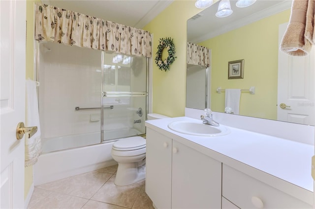 full bathroom featuring tile patterned floors, ornamental molding, vanity, shower / bath combination with glass door, and toilet