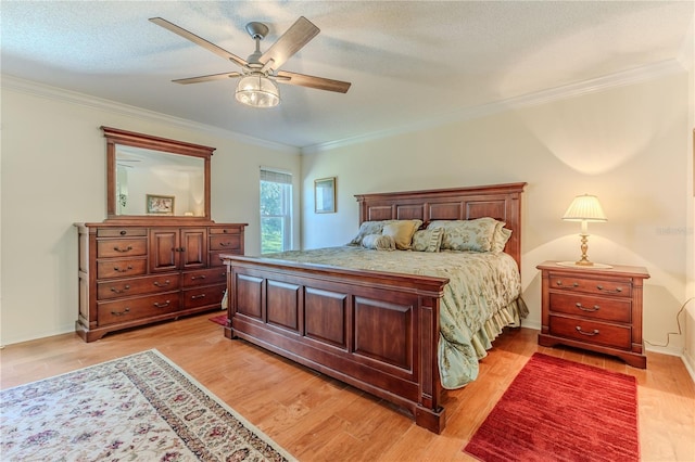 bedroom with a textured ceiling, ceiling fan, crown molding, and light hardwood / wood-style flooring