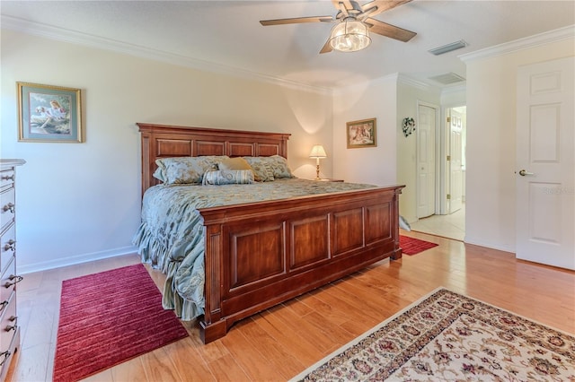 bedroom featuring light hardwood / wood-style flooring, ceiling fan, and crown molding