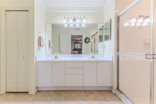 bathroom featuring vanity, tile patterned floors, a shower with door, and crown molding