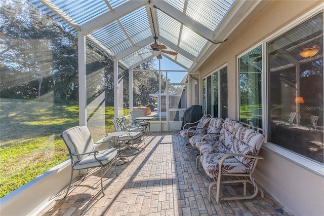 sunroom with ceiling fan and lofted ceiling