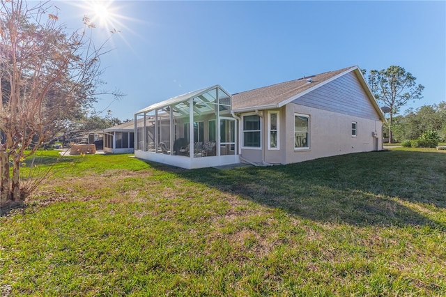 back of property featuring a yard, a lanai, and a sunroom