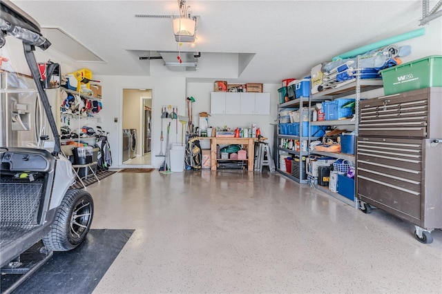 garage with a garage door opener and washer and clothes dryer