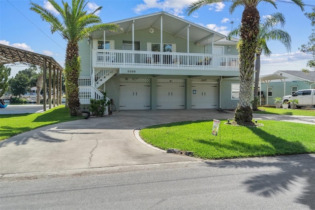 coastal inspired home featuring a front lawn and a garage