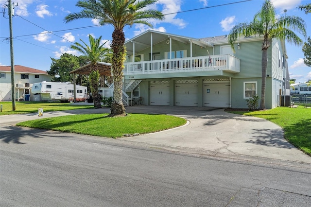 view of front facade with cooling unit, a front lawn, and a garage