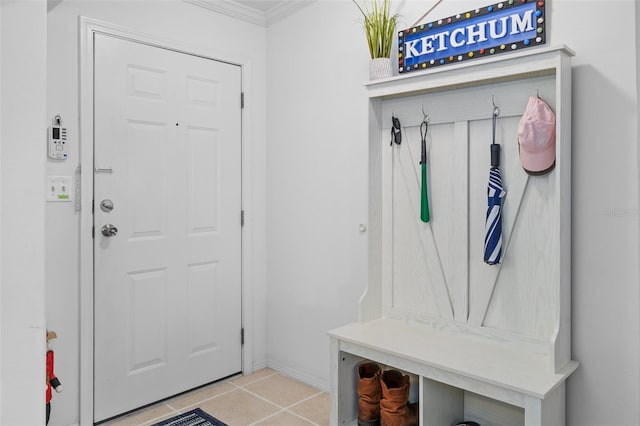 mudroom with crown molding and light tile patterned flooring