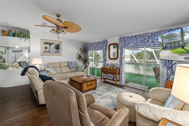 living room with dark hardwood / wood-style flooring, ceiling fan, and ornamental molding