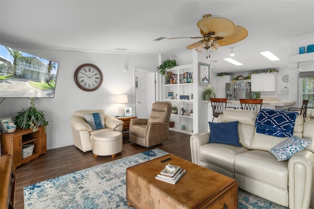 living room with ceiling fan, dark hardwood / wood-style flooring, and ornamental molding