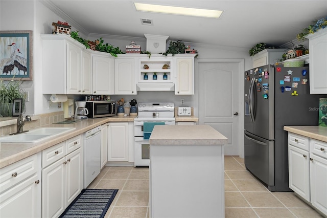 kitchen with white cabinets, a kitchen island, sink, and appliances with stainless steel finishes