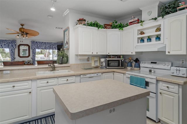 kitchen featuring kitchen peninsula, white cabinetry, sink, and white appliances