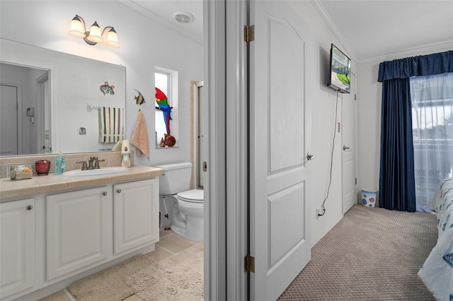 bathroom with toilet, plenty of natural light, vanity, and ornamental molding