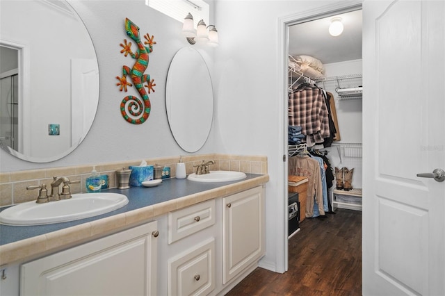 bathroom featuring backsplash, vanity, and wood-type flooring