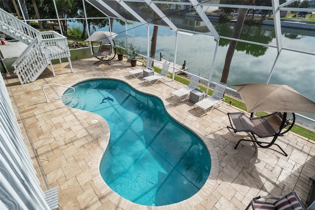 view of pool with a water view, a lanai, and a patio area