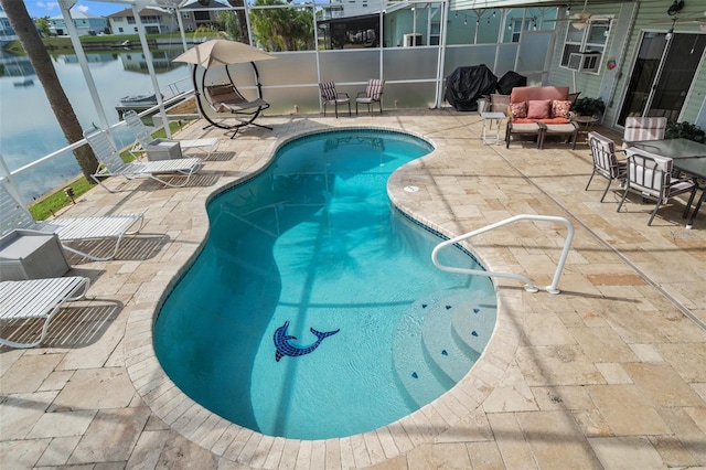 view of swimming pool featuring a lanai, outdoor lounge area, a water view, and a patio