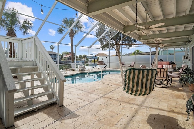 view of pool featuring glass enclosure and a patio