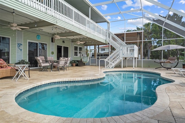 view of swimming pool featuring a lanai, ceiling fan, and a patio area