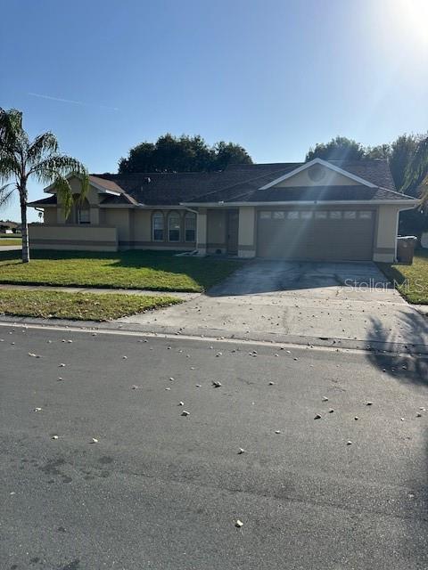 view of front of property with a front yard and a garage