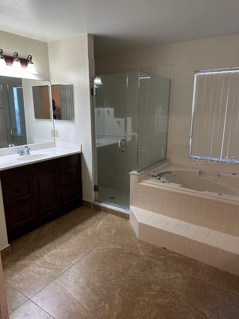 bathroom with plus walk in shower and vanity