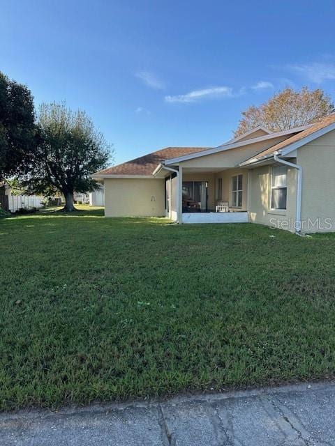 view of home's exterior with a lawn