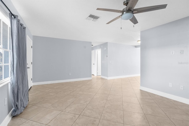 empty room featuring ceiling fan and light tile patterned floors