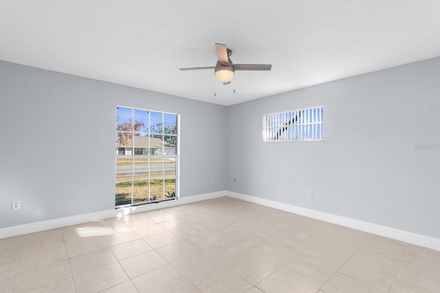 tiled empty room with ceiling fan