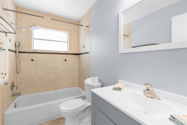 full bathroom with tile patterned flooring, tiled shower / bath combo, toilet, and vanity