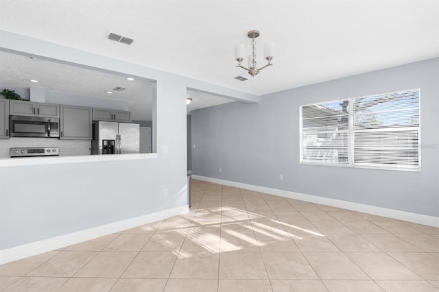 interior space featuring light tile patterned floors and an inviting chandelier