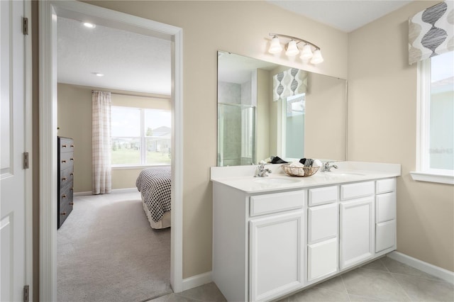 bathroom featuring tile patterned flooring, vanity, and a textured ceiling