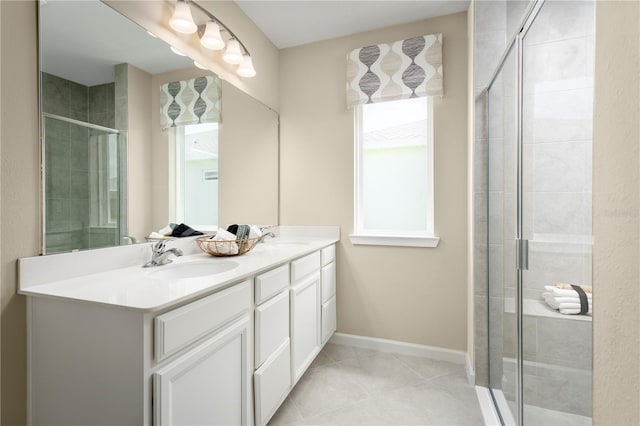 bathroom with tile patterned floors, vanity, and an enclosed shower