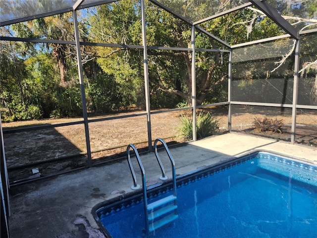 view of pool featuring glass enclosure