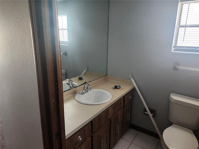 bathroom featuring toilet, tile patterned floors, and vanity