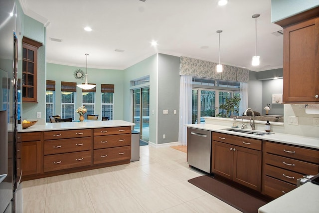 kitchen featuring backsplash, ornamental molding, sink, decorative light fixtures, and dishwasher