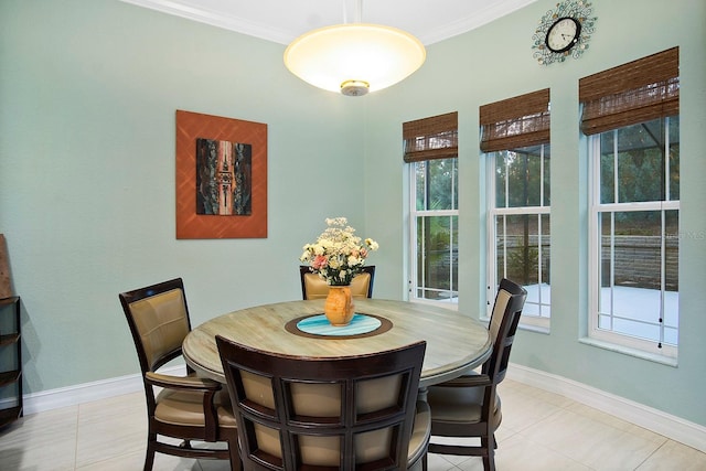 tiled dining room featuring crown molding