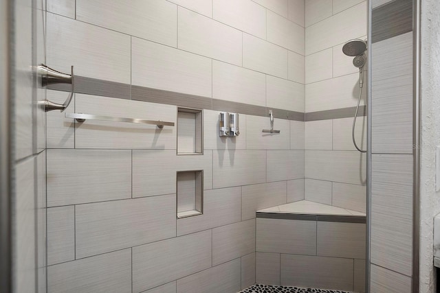 bathroom with a tile shower