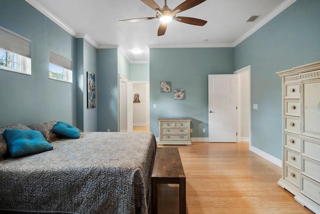 bedroom with ceiling fan, light hardwood / wood-style flooring, and crown molding