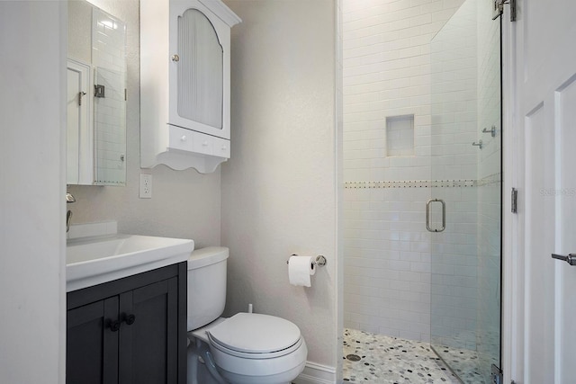 bathroom featuring vanity, toilet, and walk in shower