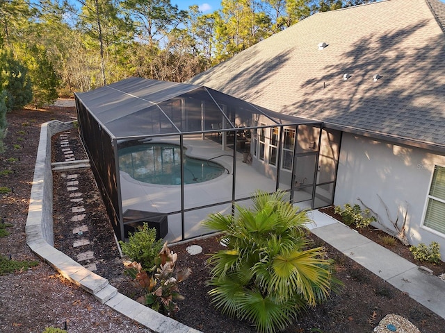 view of swimming pool featuring a jacuzzi, a patio area, and a lanai