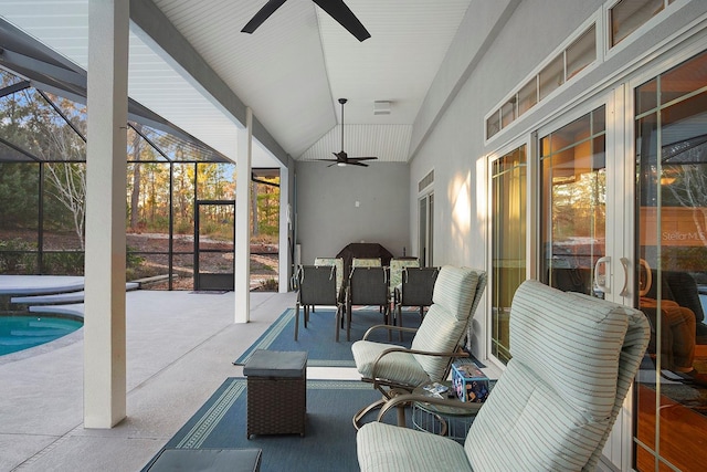 sunroom / solarium featuring ceiling fan, a swimming pool, and lofted ceiling