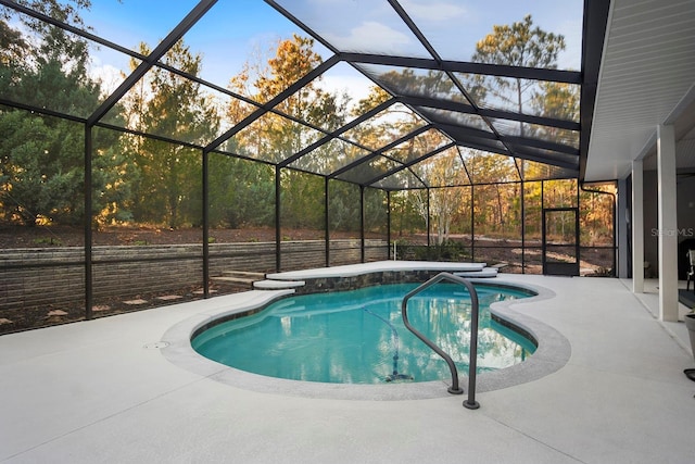 view of swimming pool featuring a lanai and a patio