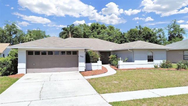 ranch-style home featuring a garage and a front yard