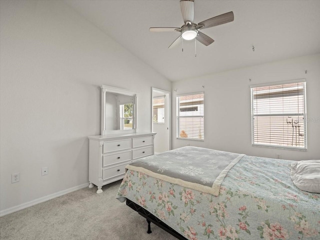 bedroom with multiple windows, ceiling fan, light carpet, and vaulted ceiling