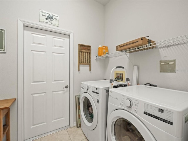 laundry room with washing machine and dryer and light tile patterned flooring