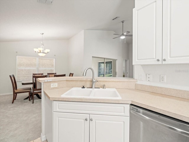 kitchen with pendant lighting, white cabinets, ceiling fan with notable chandelier, sink, and stainless steel dishwasher