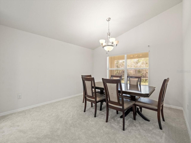 carpeted dining room with vaulted ceiling and a notable chandelier