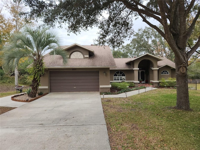 view of front of house with a garage and a front yard