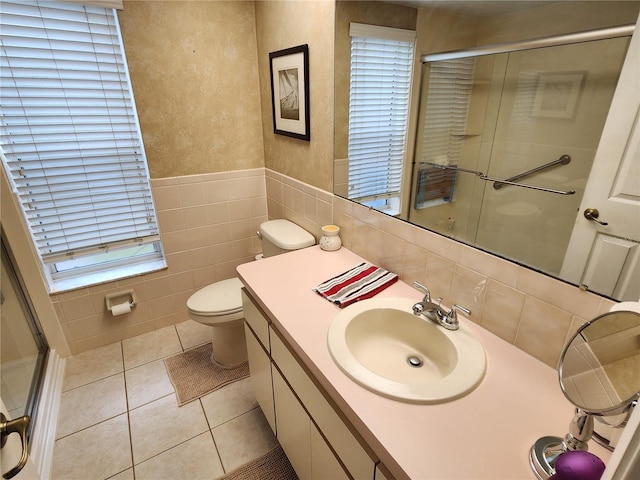 bathroom with toilet, tile patterned flooring, vanity, and walk in shower