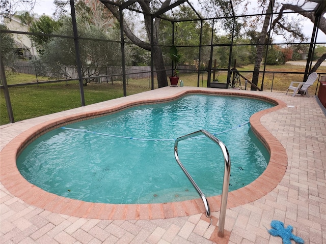 view of swimming pool with a lanai, a yard, and a patio