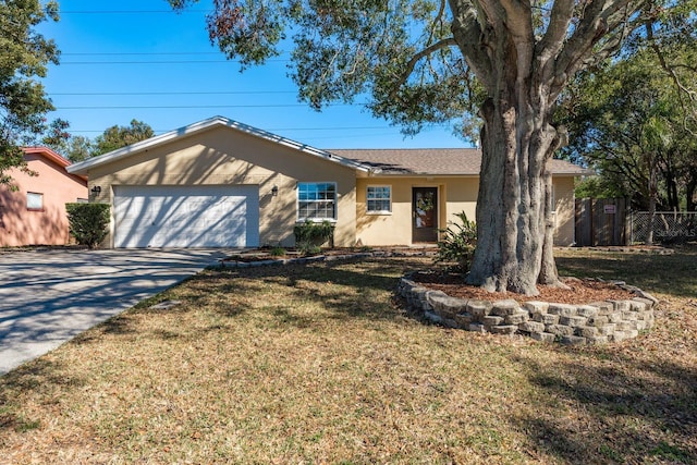 ranch-style home featuring a garage and a front lawn